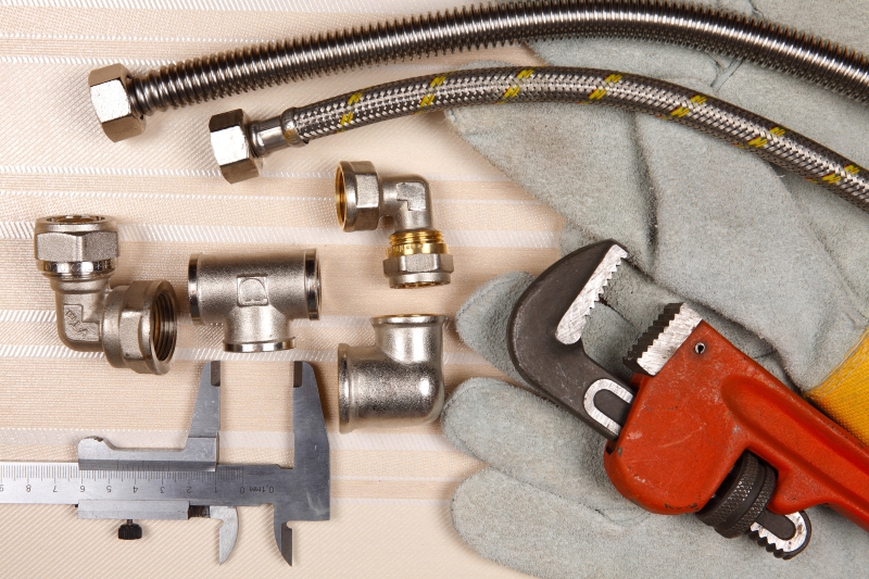 Plumber working on pipes in a Islington home